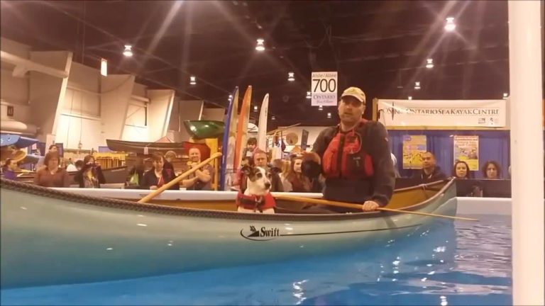 Preston and dog Nancy in a canoe in a pool at the outdoor show
