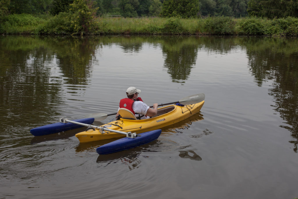 A an accessible kayak is paddled down the river