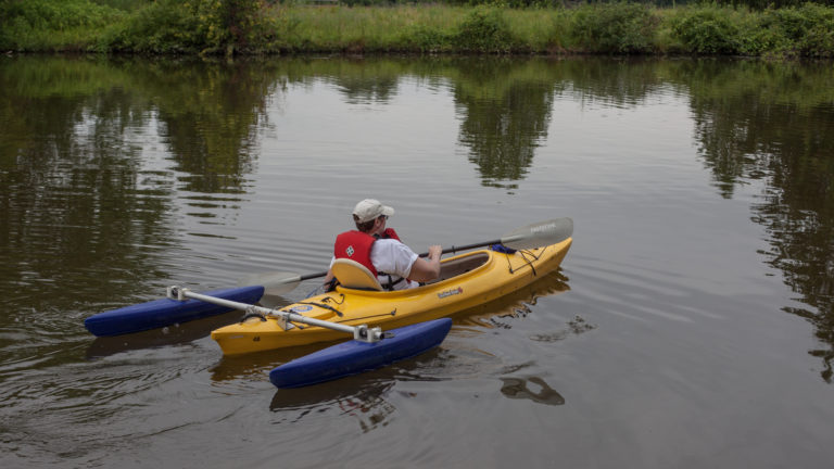 A an accessible kayak is paddled down the river