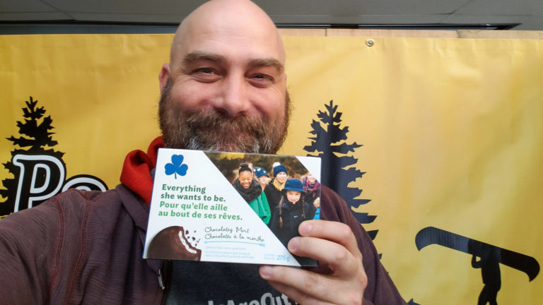 Preston smiles as he was given a box of Girl Scout cookies
