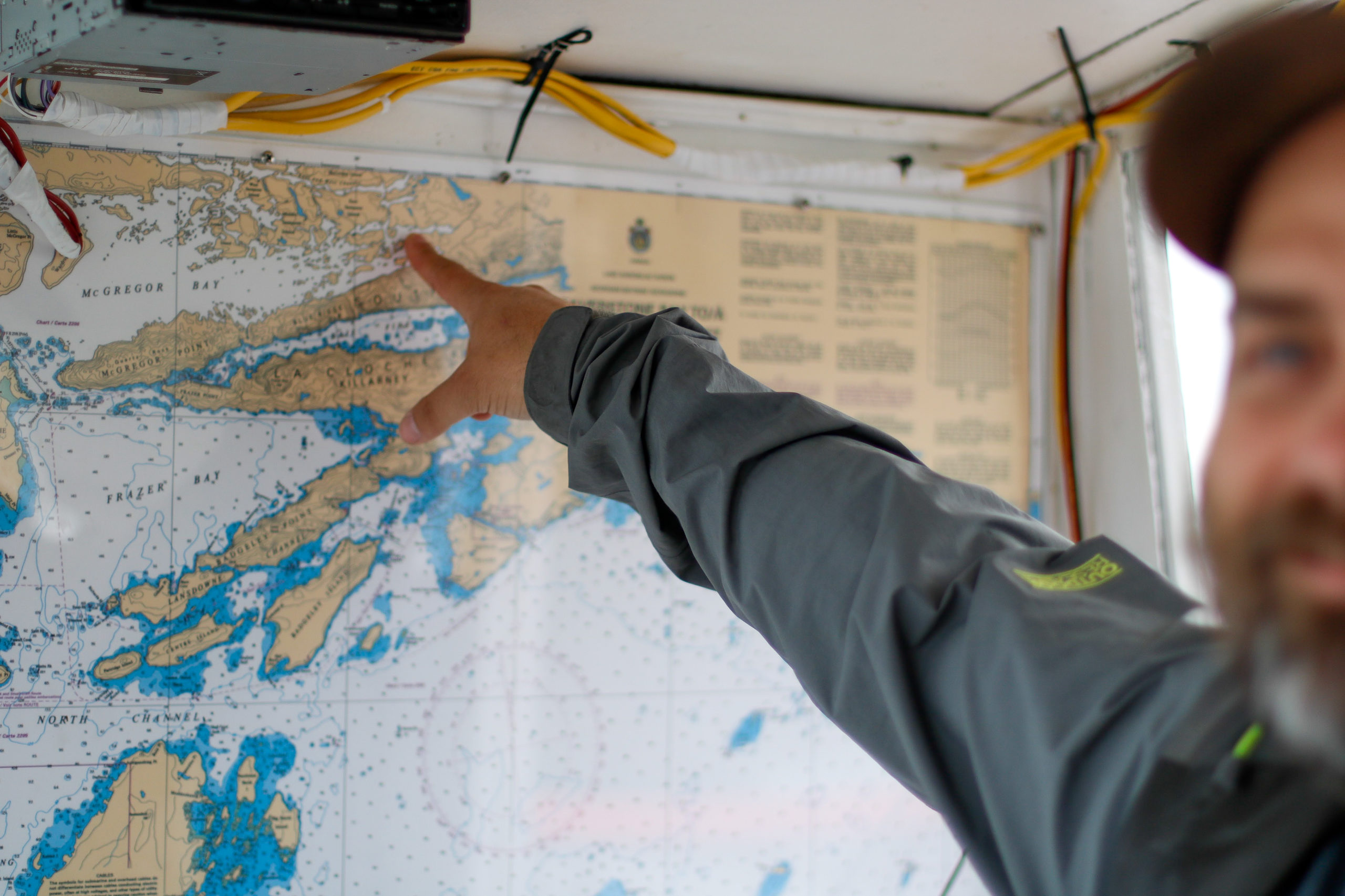 Preston points to a map of Killarney within a water taxi from Killarney Outfitters