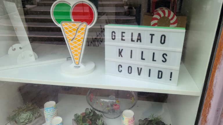 Sign in a gelato shop that suggests it cures Covid-19